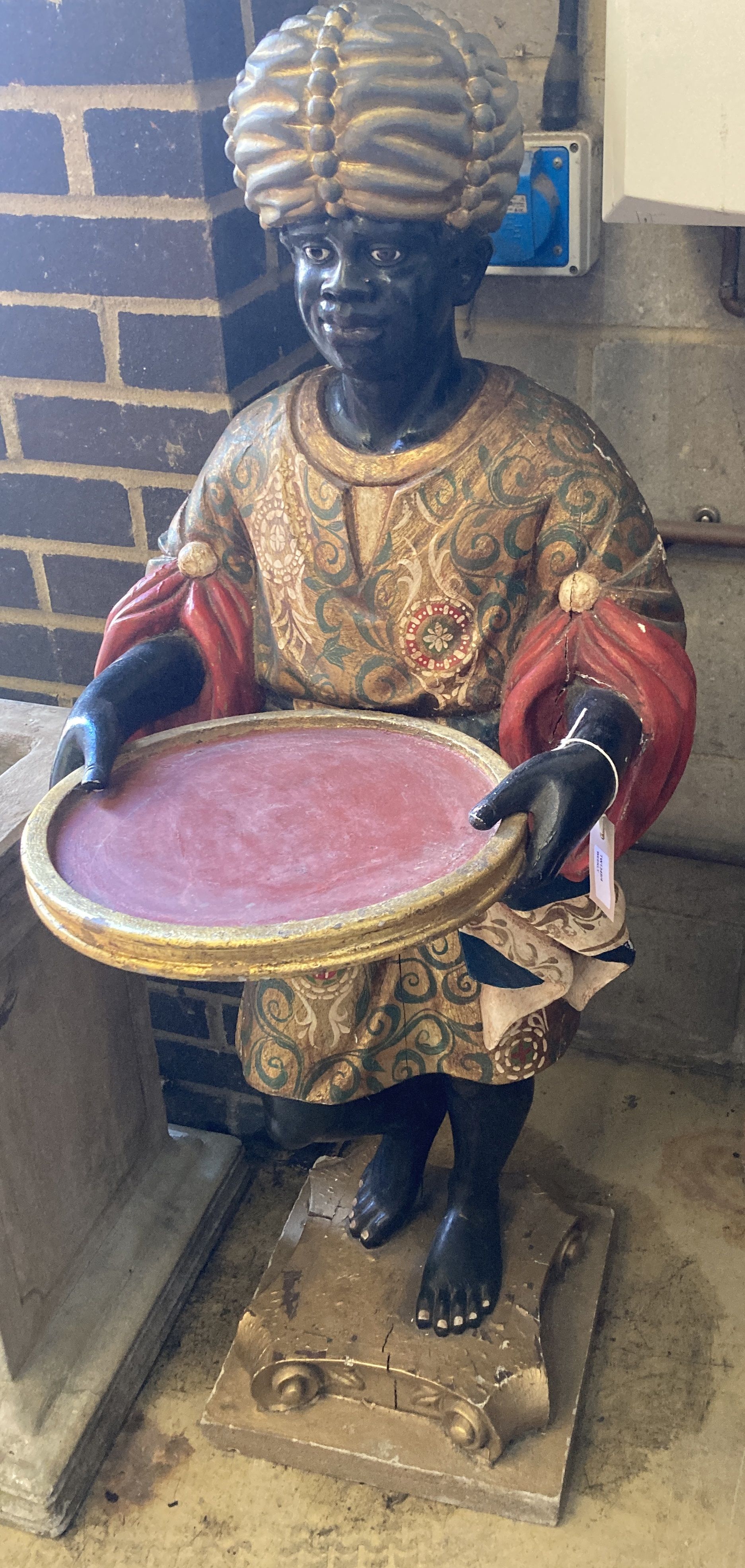 A carved, painted and gilded wood figural dumb waiter,